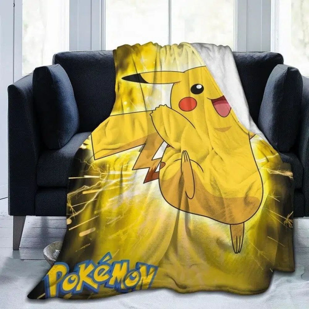 Pokémon Pikachu manta amarilla para los niños en un sofá negro delante de una ventana