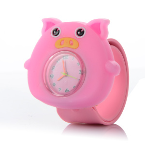 Un reloj infantil con la forma de un simpático cerdo rosa. En su centro hay una esfera de cristal con agujas y números de colores.