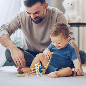 Juego de dentición de silicona Montessori para bebés con fondo, un papá con su bebé